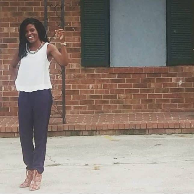 Jasmine Brown celebrating in front of an investment property